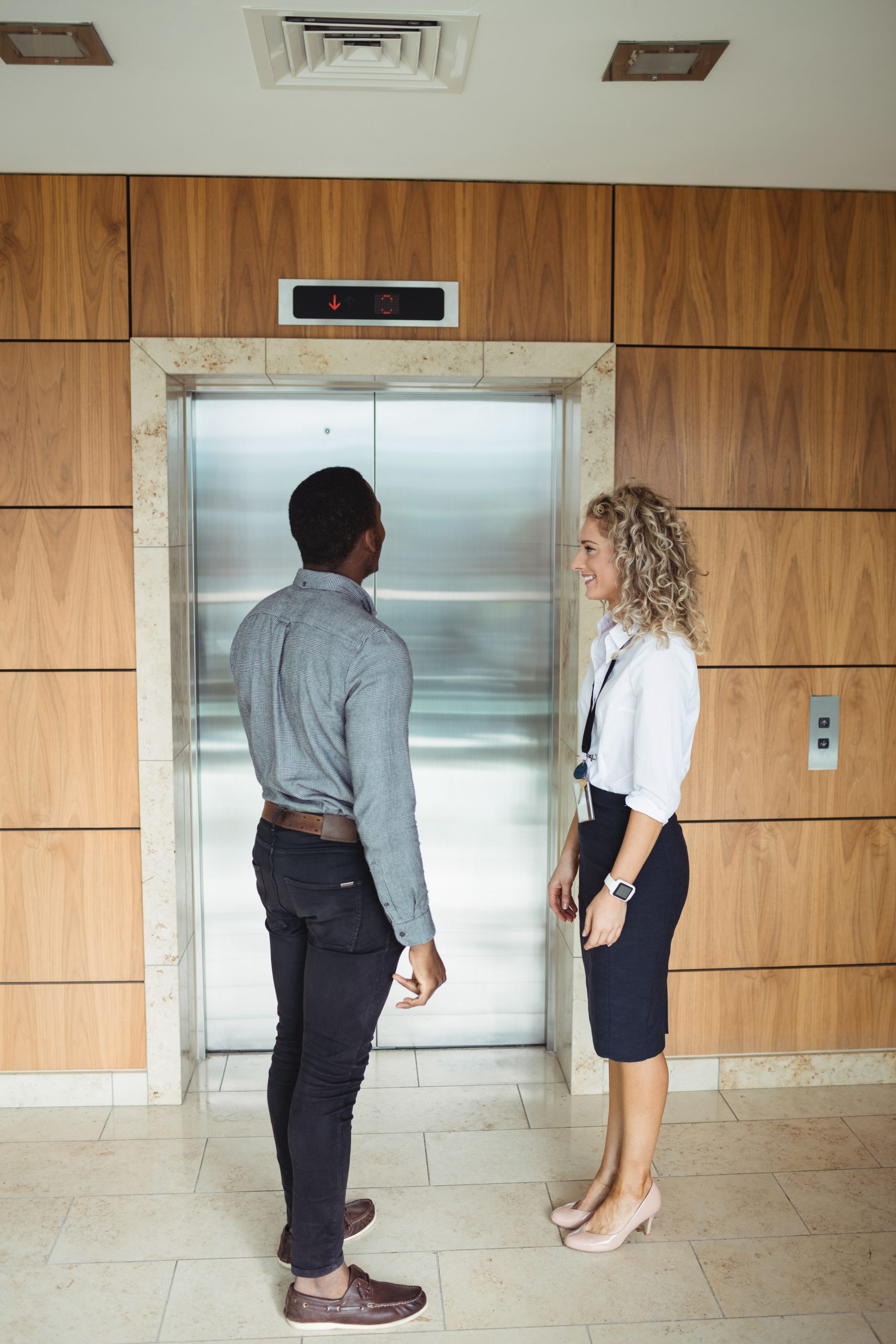 Business executive waiting for lift in office